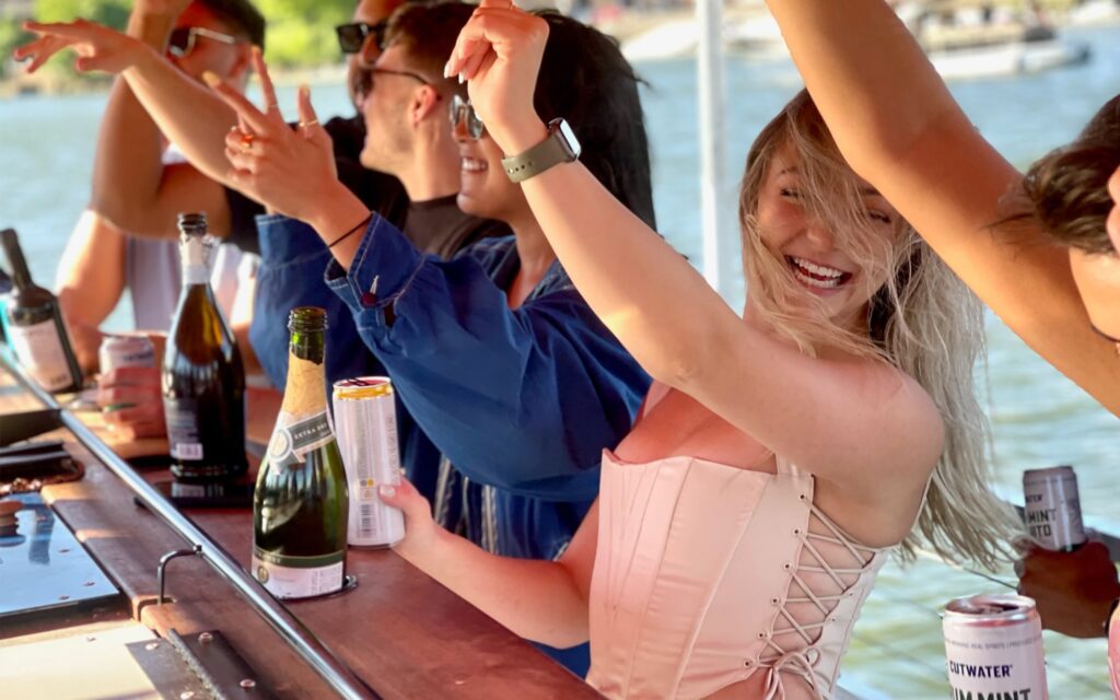 People partying on a Washington DC booze cruise. Potomac Paddle Club by Sea Suite Cruises.