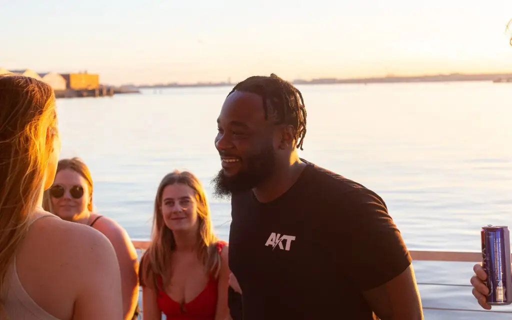 Man smiling on a Navy Yard booze cruise near Washington DC. Potomac Paddle Club by Sea Suite Cruises.