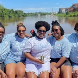 Smiling ladies posing for a picture on a bachelorette party cruise in Richmond VA by Sea Suite Cruises RVA.