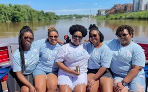 Smiling ladies posing for a picture on a bachelorette party cruise in Richmond VA by Sea Suite Cruises RVA.