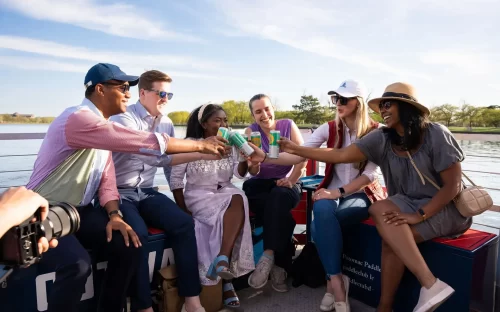 People drinking beer on a Washington DC paddle boat cruise at the Wharf. Potomac Paddle Club by Sea Suite Cruises.